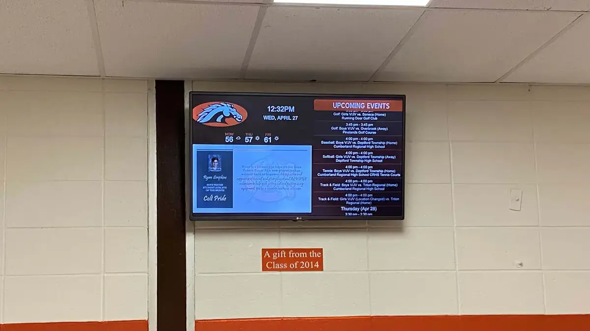 Cumberland Regional High School hallway digital signage, gift from senior class, displaying upcoming events and student spotlight, Reach Media Network