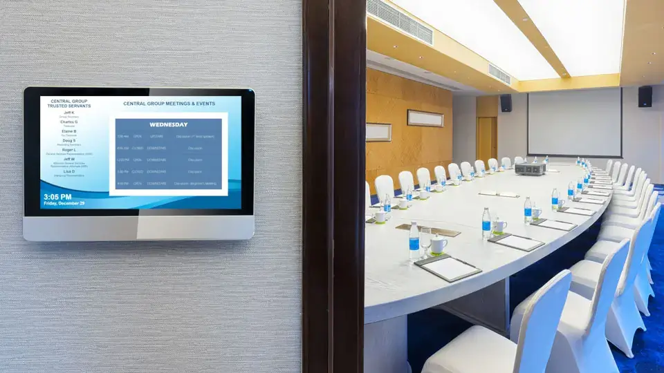 Corporate digital signage from Reach Media Network displaying room schedule for conference room.
